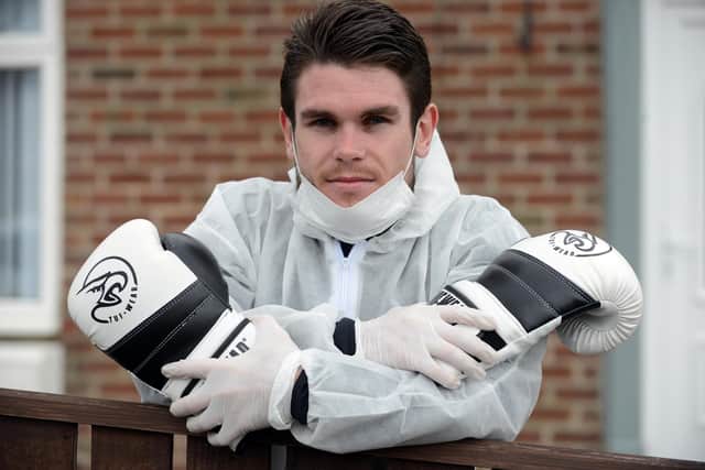 Professsional boxer Tommy Ward prepares to walk a 30-mile charity walk in PPE.