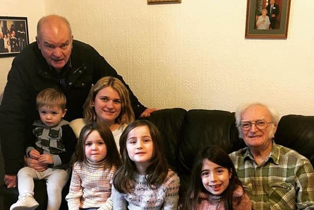 Harry pictured with his son Keith, pictured left rear, granddaughter Sophie, and four of his great grandchildren.