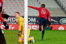 Lille's French  forward Isaac Lihadji (R) celebrates after scoring the opening goal  during the French L1 football match between Lille (LOSC) and Lorient (FCL) at the Pierre Mauroy Stadium Villeneuve-d'Ascq, northern France, on January 19, 2022. (Photo by DENIS CHARLET / AFP) (Photo by DENIS CHARLET/AFP via Getty Images)
