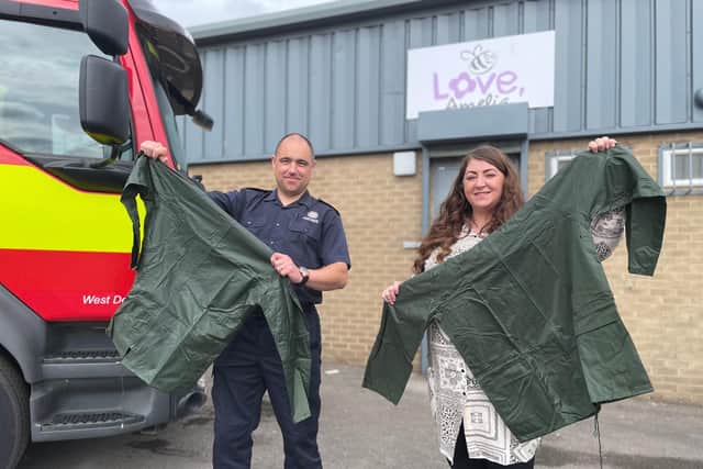Andrew Lane of TWFRS and Steph Archbold of Love, Amelia pictured outside of the charity’s offices holding an example of the waterproof jackets.