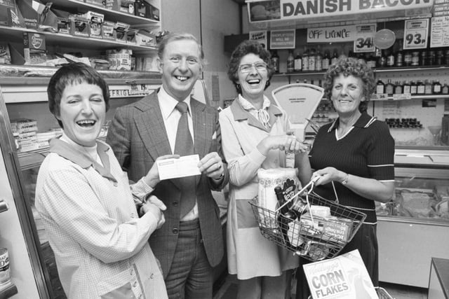 Raising money for charity at M & S Lindoe's VG Store in 1980. Owner, S Lindoe raffled a hamper of groceries. Pictured receiving a cheque from assistant, Jean Waterson is George Cooper, on behalf of the charity.  Receiving her winning hamper from assistant Jessie Laws is Olive Gromson.