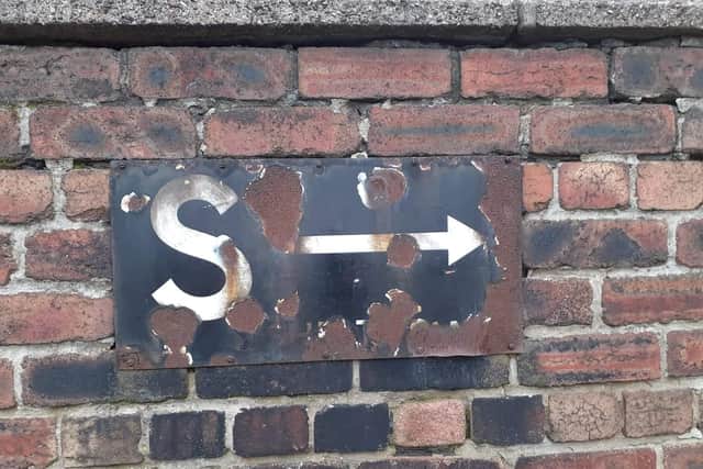 The sign used to point to an air raid shelter during World War II.