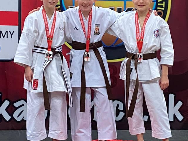 Riley Rogerson, centre, with his gold medal.