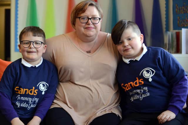 Brothers Billy, eight, and Henry Gibbon, seven with mum Sue Gibbon, after completing their 50 mile charity run for the Stillbirth and Neonatal Death Society (SANDS).