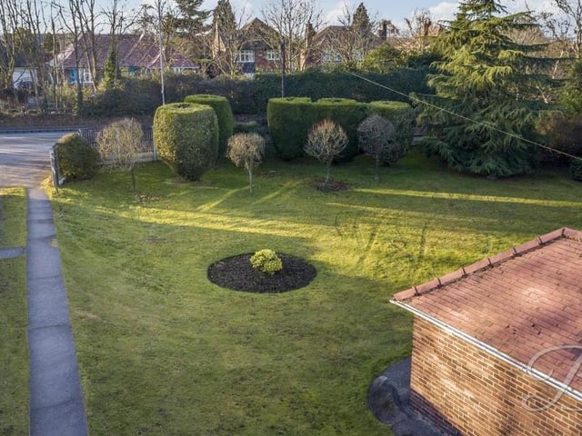 The drone has also captured this aerial shot of the front garden and driveway. The shrubs and trees are strategically positioned to add to the feeling of privacy.