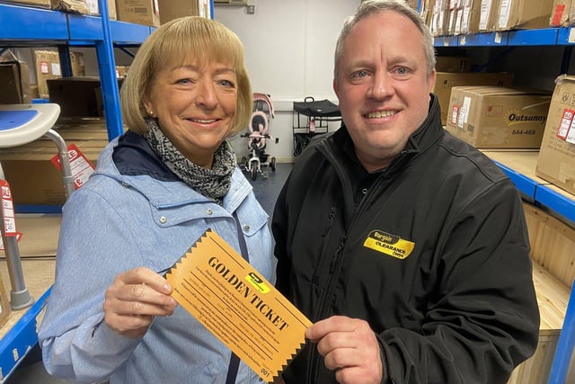 Susan Oversby is presented with her golden ticket to go into a draw to win shopping discount vouchers. 

Picture by FRANK REID