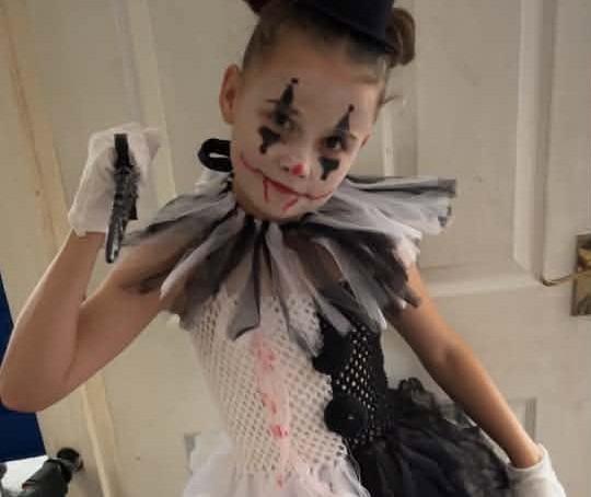 Amelia Kellett, age eight, dresses up as a clown.