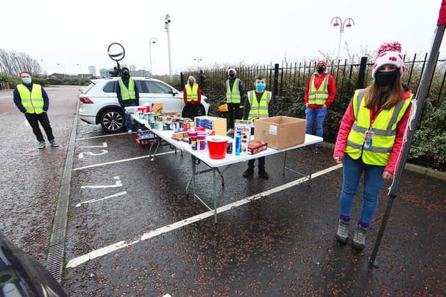 Sophie Ashcroft, front, from the Foundation of Light and Red and White Army volunteers man the food bank donation table at the Stadium of Light.  Picture by Frank Reid.