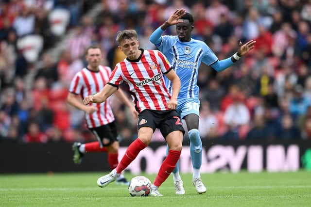 SUNDERLAND, ENGLAND - JULY 31: Sunderland player Dan Neil is challenged by Coventry player Fabio Tavares during the Sky Bet Championship between Sunderland and Coventry City at Stadium of Light on July 31, 2022 in Sunderland, England. (Photo by Stu Forster/Getty Images)