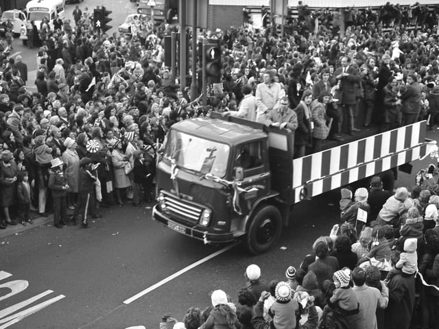 No gaps in the crowds as the parade winds its way on past the Wheatsheaf.