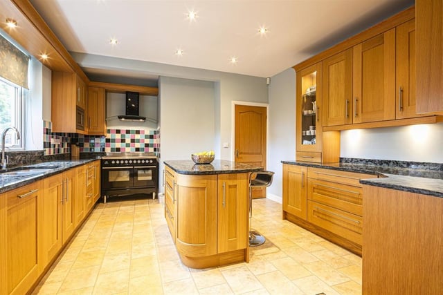 The extended breakfast kitchen has granite work surfaces and a central island unit.