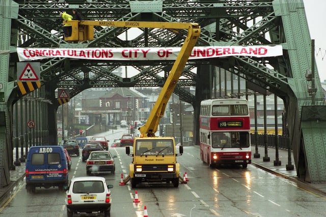 Workmen erect the city sign on Wearmouth Bridge to mark Sunderland's first full day as a city in February 1992.