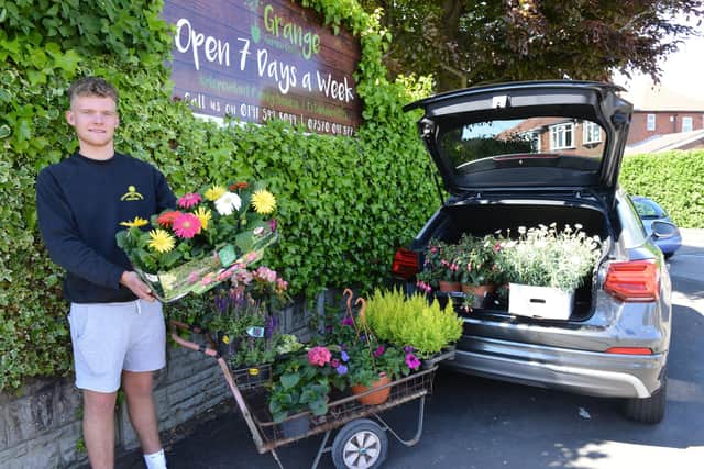 Christian Carney owner of the Grange Garden Centre loading his car to make a delivery. Picture by FRANK REID