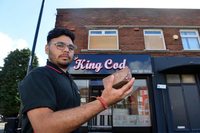 Sagar Saihi with the brick that was used to smash the glass on his flat window in what was the second of two attacks.