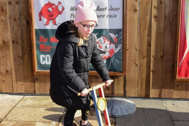 Lilly Durnan-Fletcher, eight, trying out one of the toys on the 1950's street at Beamish Museum.