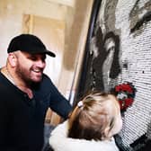 Darren Timby and his daughter Belle check out the artwork so far.