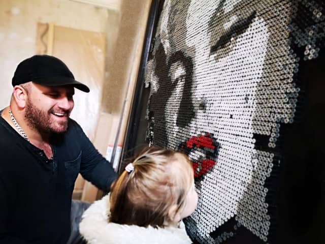 Darren Timby and his daughter Belle check out the artwork so far.