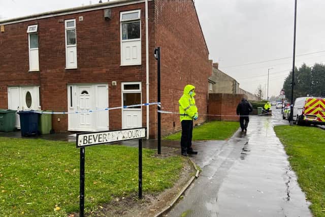 A police cordon is in place after a man wearing blood-stained clothes knocked on a window of a house in Beverley Court this morning.