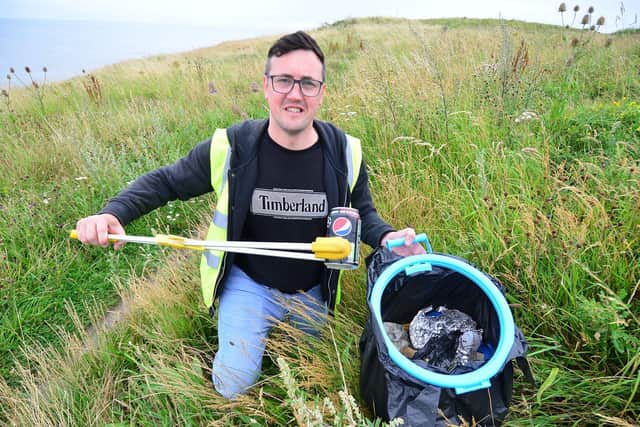 Former Sunderland City Councillor, Michael Mordey, picking litter as he makes his way along the pathway above Hendon Beach.

Picture by Frank Reid