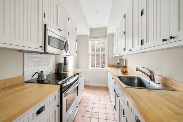 The east-facing kitchen in the upper duplex overlooks the garden.