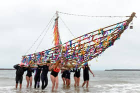 The Greek galley is taken into the sea at Roker Beach by local wild swimmers as part of the The National Theatre play.