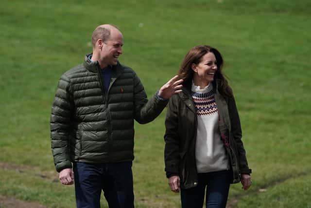 The Duke and Duchess of Cambridge walk together during their visit to Manor Farm