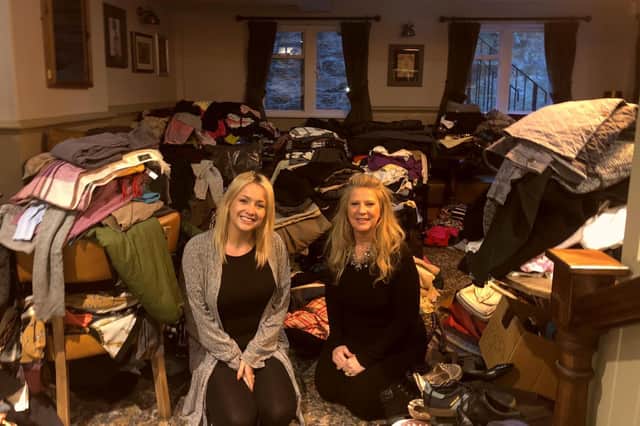 Rotarian Kimberley Cheetham and Amy Calvert with clothes donated so far by the community.