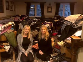 Rotarian Kimberley Cheetham and Amy Calvert with clothes donated so far by the community.
