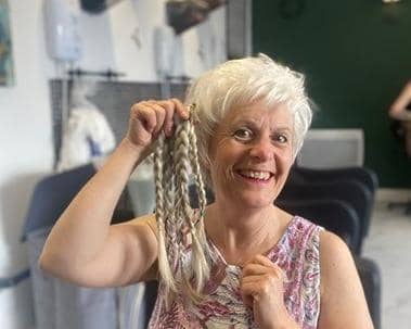 Jane Mills with the 13 inches of hair she gave up for charity at The Hairdresser on the Corner.