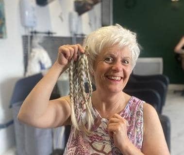 Jane Mills with the 13 inches of hair she gave up for charity at The Hairdresser on the Corner.