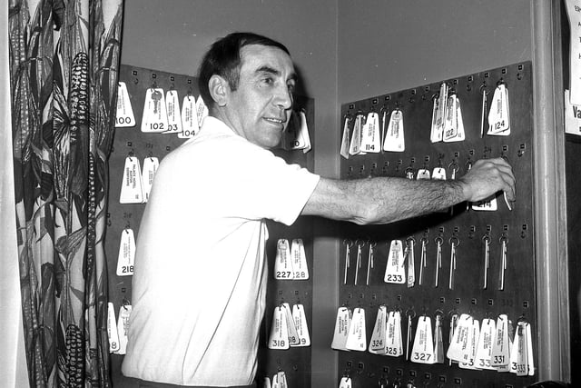 Manager Bob Stokoe collects his keys at the hotel.