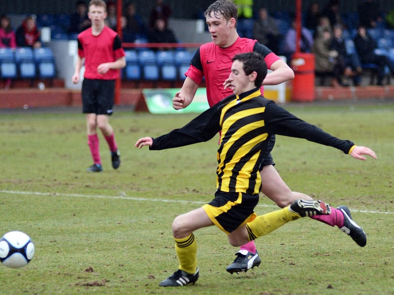 Pride of Shirebrook (pink strip) face Ashfield Scaffolding in the U18's final at Alfreton Town in May 2013.