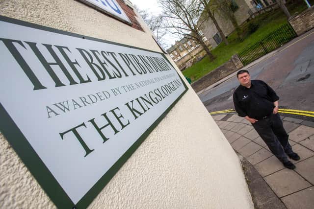 The Kingslodge Inn general manager Darren Winder with the "unauthorised" sign which Durham County Council have ordered the pub to remove.