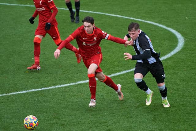 Luke Chambers of Liverpool and Jay Turner-Cooke of Newcastle United battle for the ball.