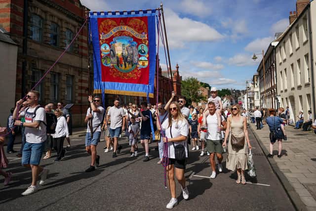 Colliery banners are carried through the city in Durham