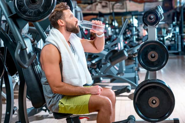 It's important to drink plenty of water while working out and in general. Photo Adobe Stock