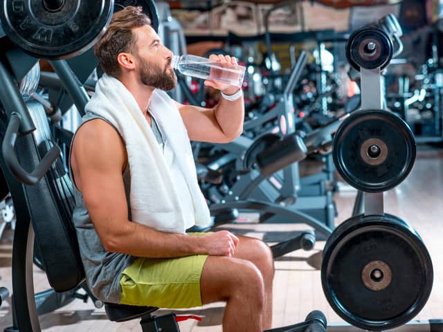 It's important to drink plenty of water while working out and in general. Photo Adobe Stock