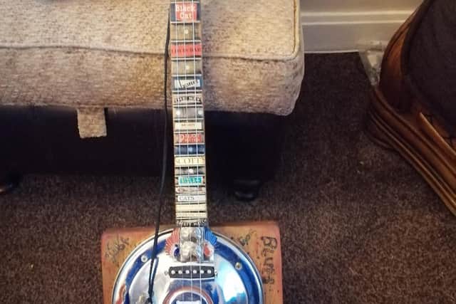 Dave's guitar which is made out of a Morris Minor hub cap, and a school desk lid.