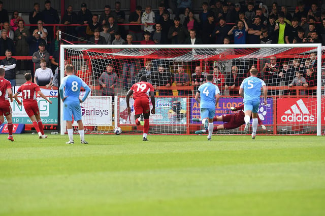 Accrington Stanley score from the penalty spot in front of spectators at the Wham Stadium.