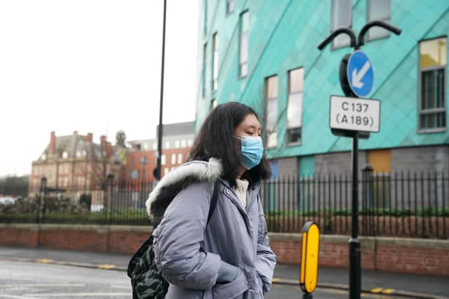 A woman wears a mask in Newcastle upon Tyne, near where two patients who have tested positive for coronavirus elsewhere in England are bring treated in the city's Royal Victoria Infirmary's high consequence infectious disease unit. PA Photo. Picture date: Friday January 31, 2020. See PA story HEALTH Coronavirus. Photo credit should read: Owen Humphreys/PA Wire 