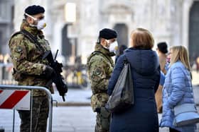 Italian soldiers wearing sanitary masks patrol downtown Milan, Italy. At least 190 people in Italy's north have tested positive for the COVID-19 virus.