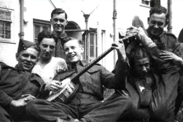 Len entertaining his comrades with his banjo during the war years