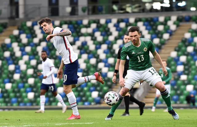 BELFAST, NORTHERN IRELAND - MARCH 28: Christian Pulisic of USA in action under pressure from Corry Evans of Northern Ireland during the International Friendly between Northern Ireland and USA at Windsor Park on March 28, 2021 in Belfast, Northern Ireland. Sporting stadiums around the UK remain under strict restrictions due to the Coronavirus Pandemic as Government social distancing laws prohibit fans inside venues resulting in games being played behind closed doors.  (Photo by Charles McQuillan/Getty Images)