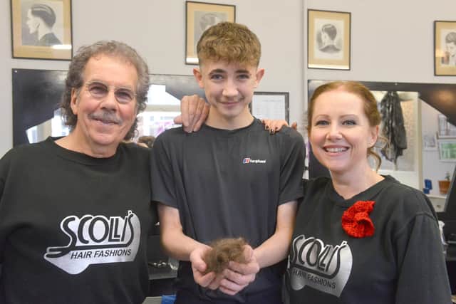 Toby Quinn with granddad John Scollen, mam Naomi Jenkins - and the sad remains of his beloved mullet. Sunderland Echo image.