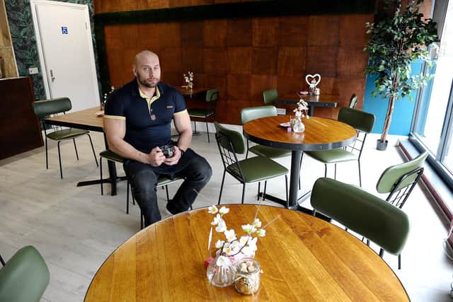 Ariel Niesporek inside his empty cake and coffee shop on Wednesday morning.