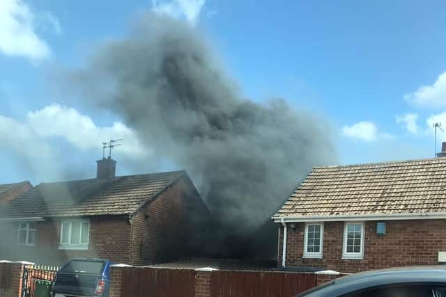 Black smoke can be seen rising at the scene