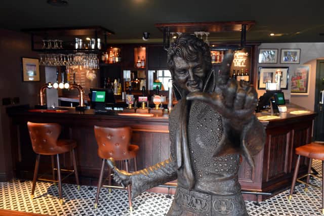 A huge Elvis welcomes people to the bar