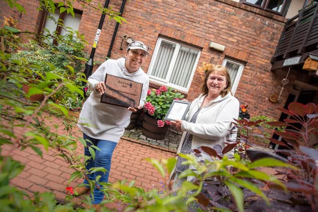 Last year's Gentoo community garden winners at Ayton Gardens with their award.