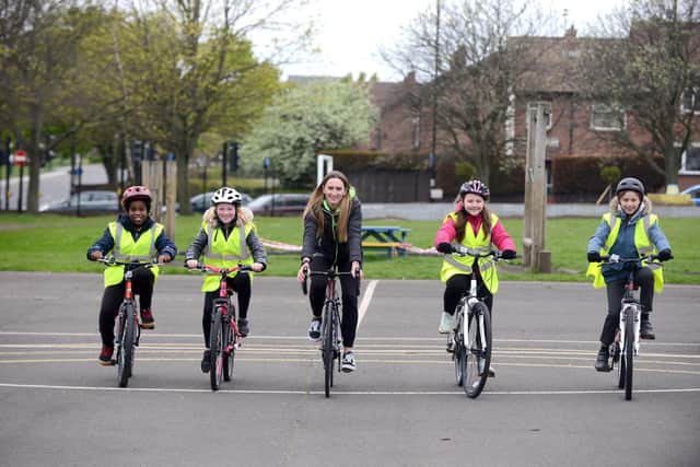 Captain of the Boompods Elite Women's Cycling Team, Hannah Farran, cycling with children from Dame Dorothy Primary School.