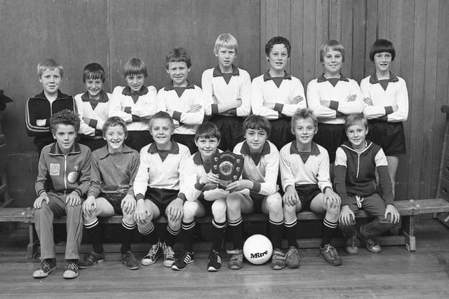 The Shiney Row School football team proudly display the trophy they won in 1980.